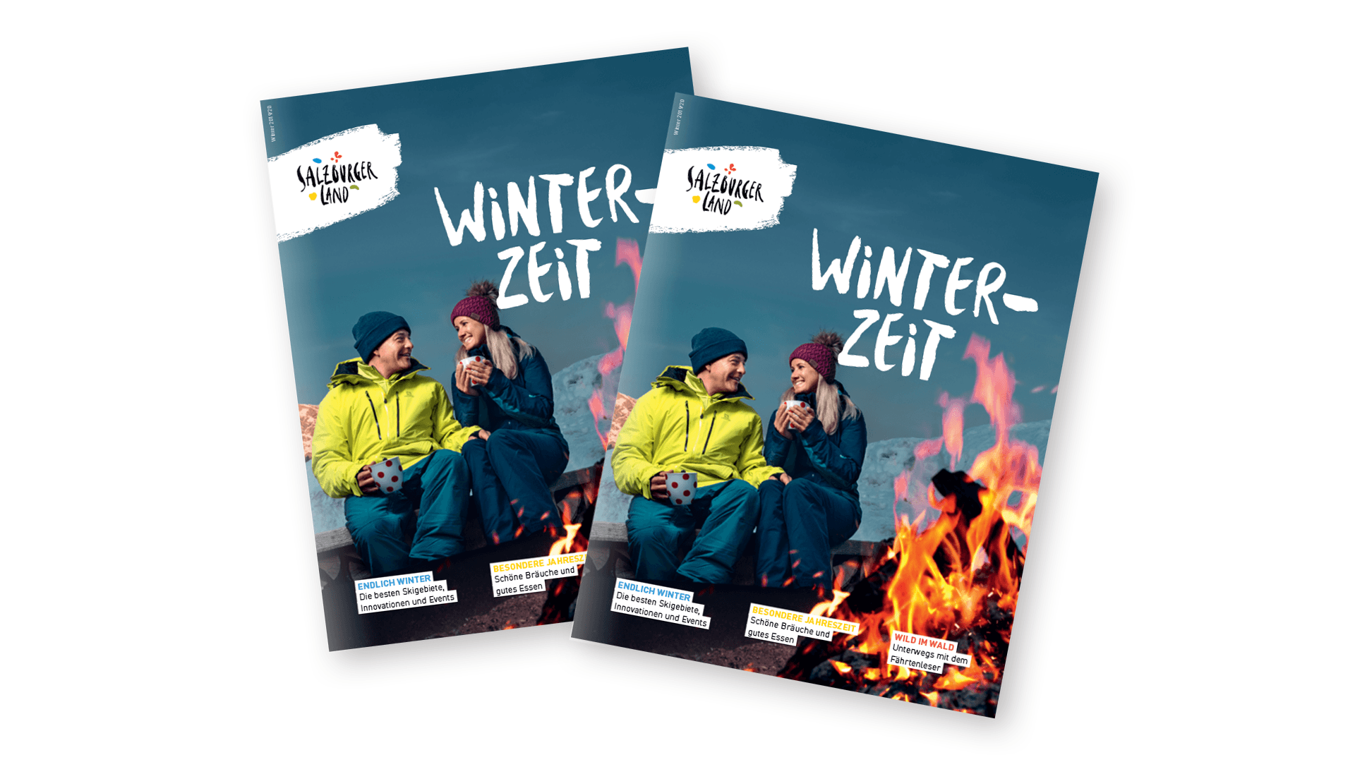 Zwei Personen in Winterkleidung sitzen an einem Lagerfeuer auf einem Magazin-Cover mit dem Titel Winter-Zeit und blauem Himmel im Hintergrund.